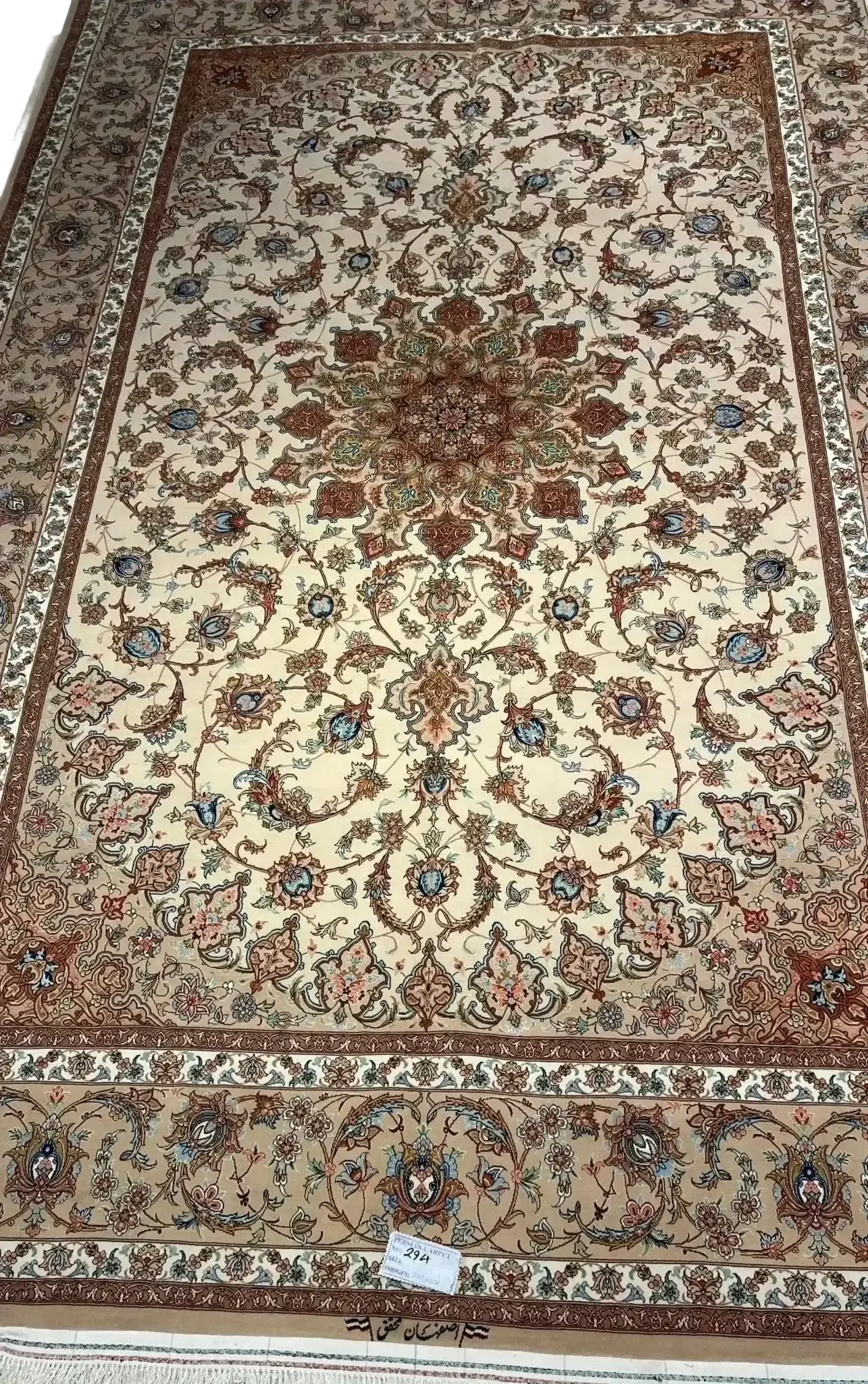 "Hand-knotted luxury Persian rug made of silk and wool from Isfahan, featuring traditional Iranian patterns, 9.8x6.5 feet, crafted by skilled weaver Mohaghegh." 